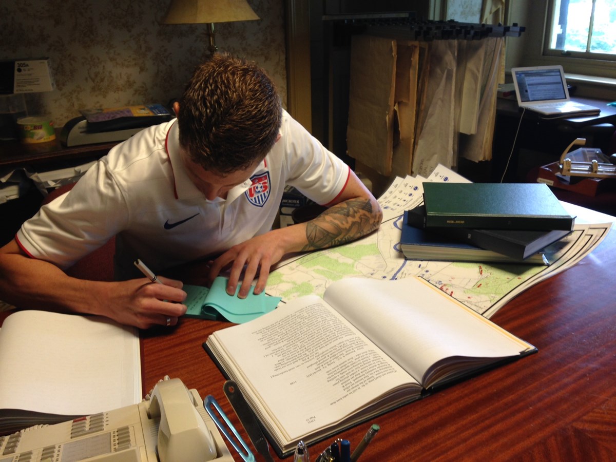 Grad student uses bound volumes and maps from research library Grad student uses bound volumes and maps from research library