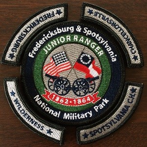 Completed Junior Ranger patch set; circular patch with rockers around it. Patch shows American and Confederate flags.