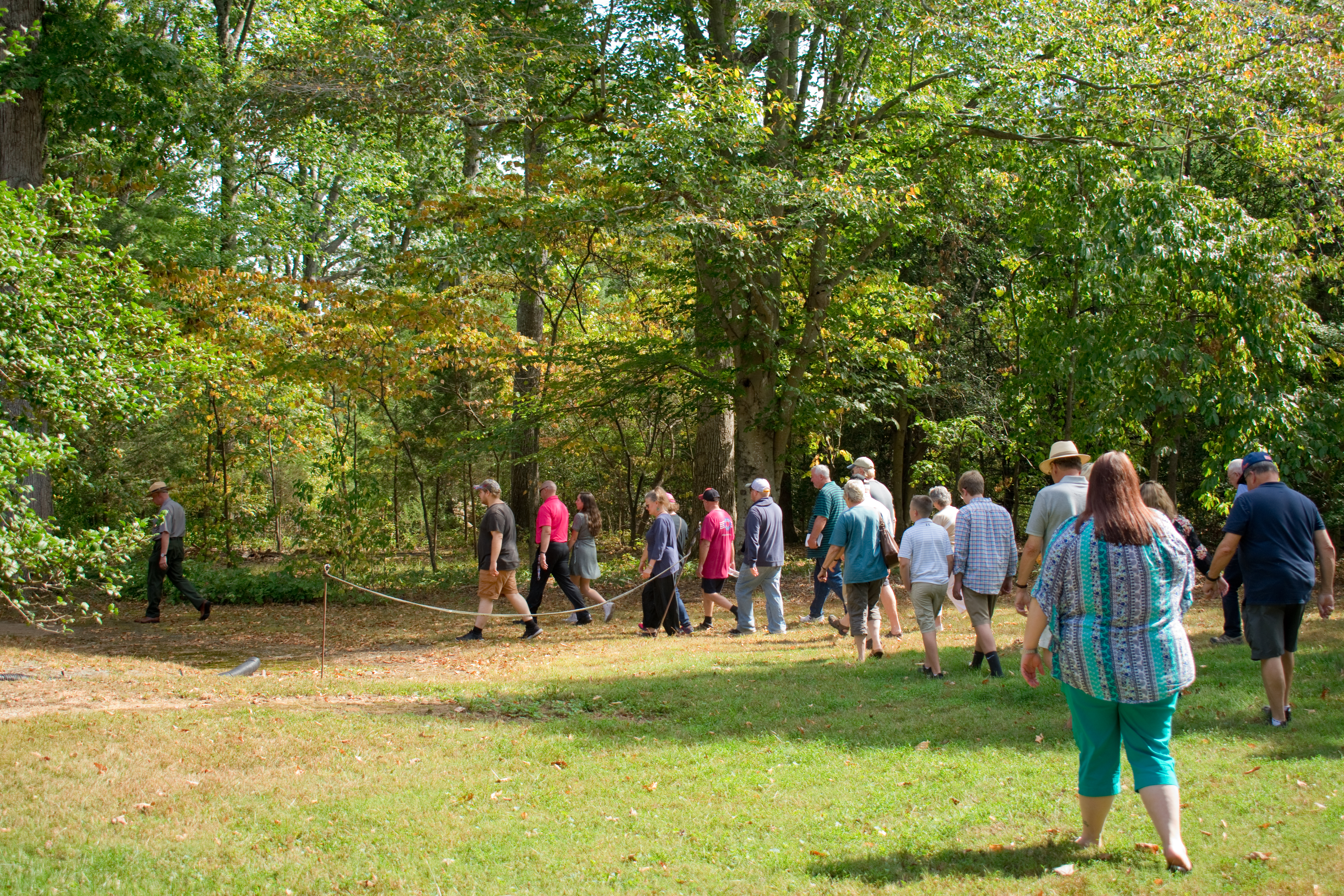 Jackson's Wounding Tour Outside Chancellorsville A line of people walking outside following a Park Ranger.