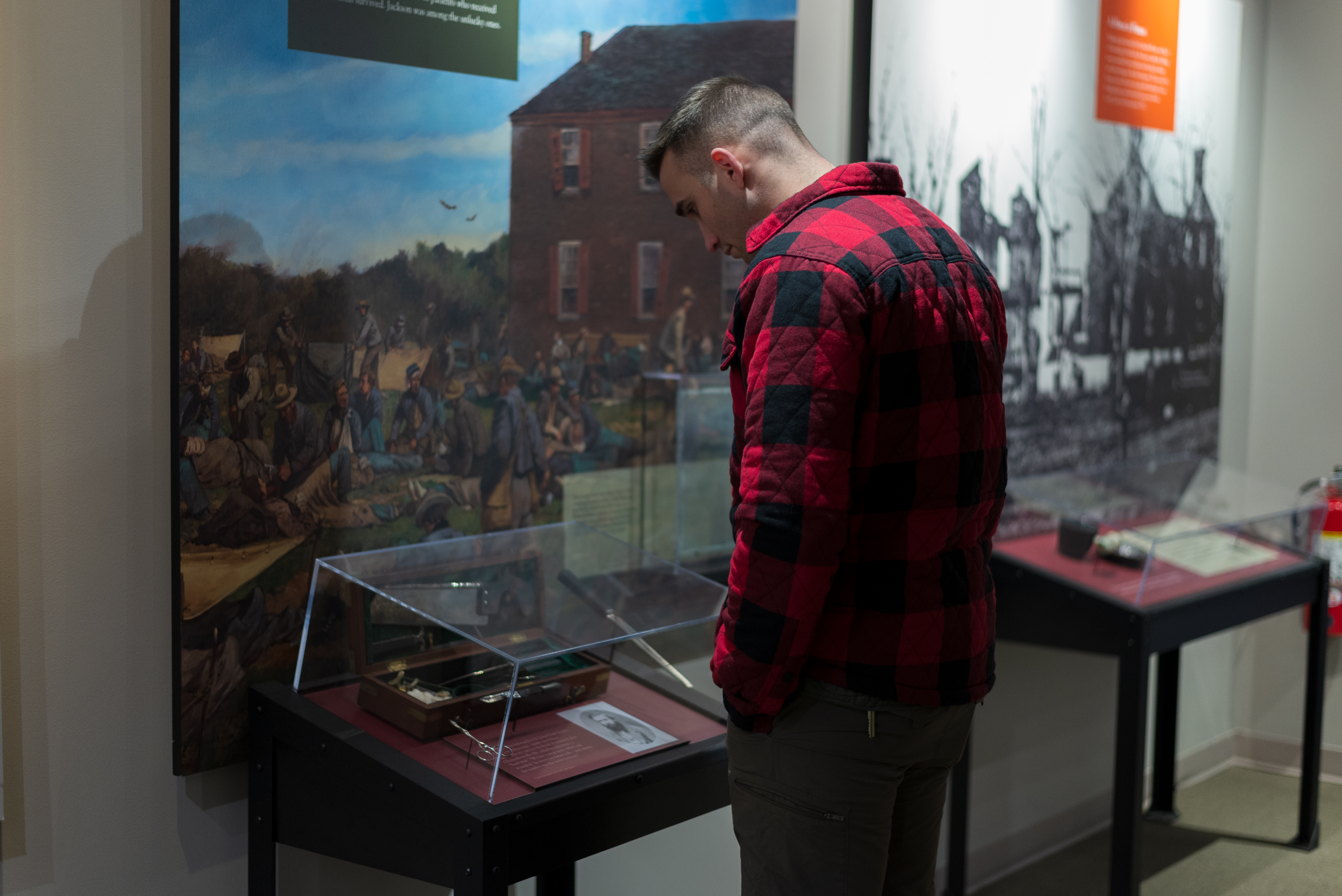 A man looking at an exhibit case.