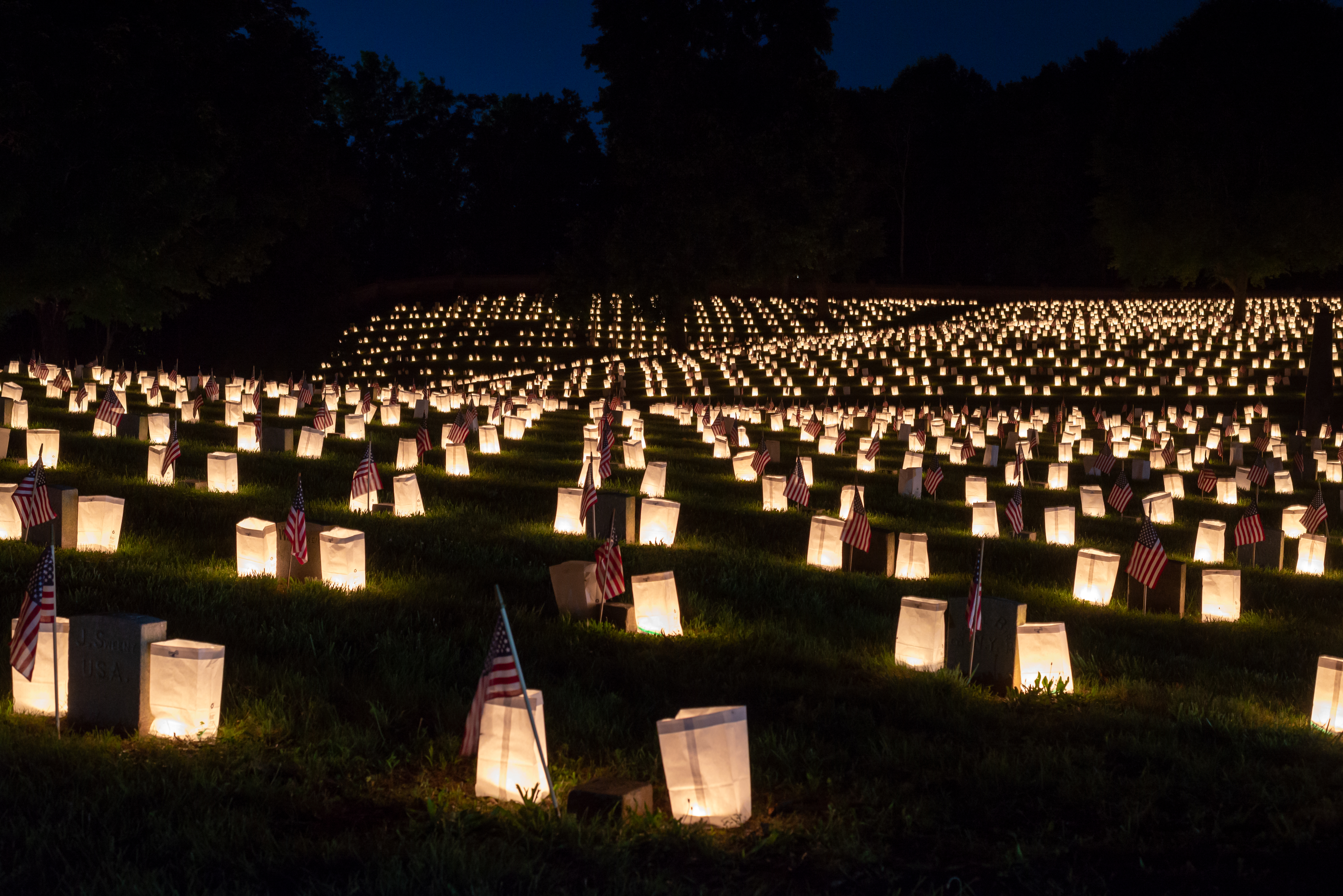 2022 Luminaria Luminary candles in paper bags dotting a national cemetery.