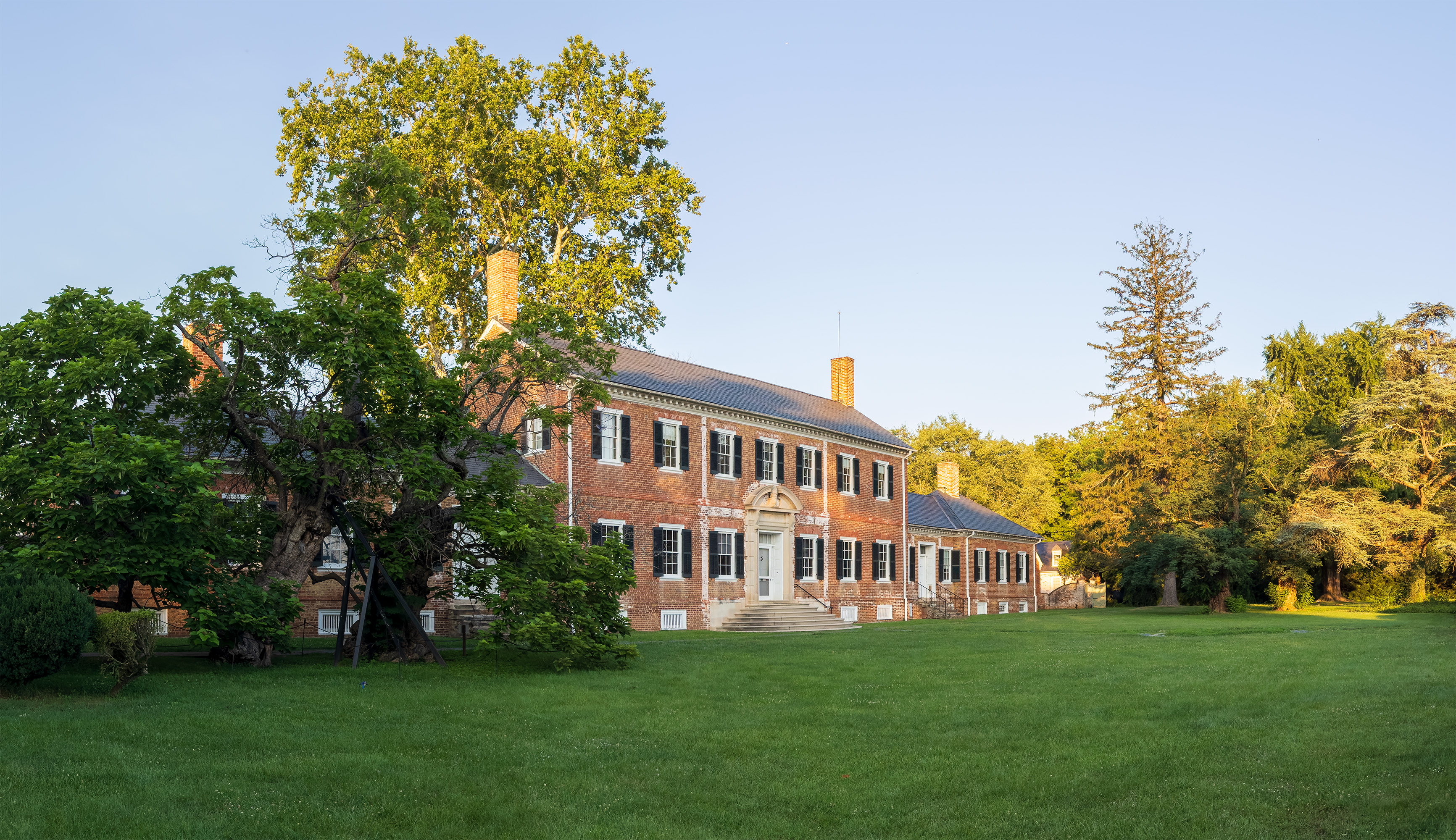 Large Georgian mansion with manicured lawn.