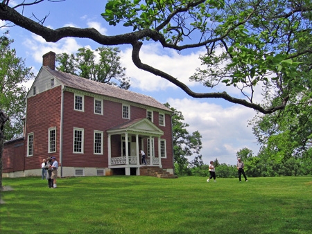 Ellwood Manor House - NPS Red building with people in the front lawn.