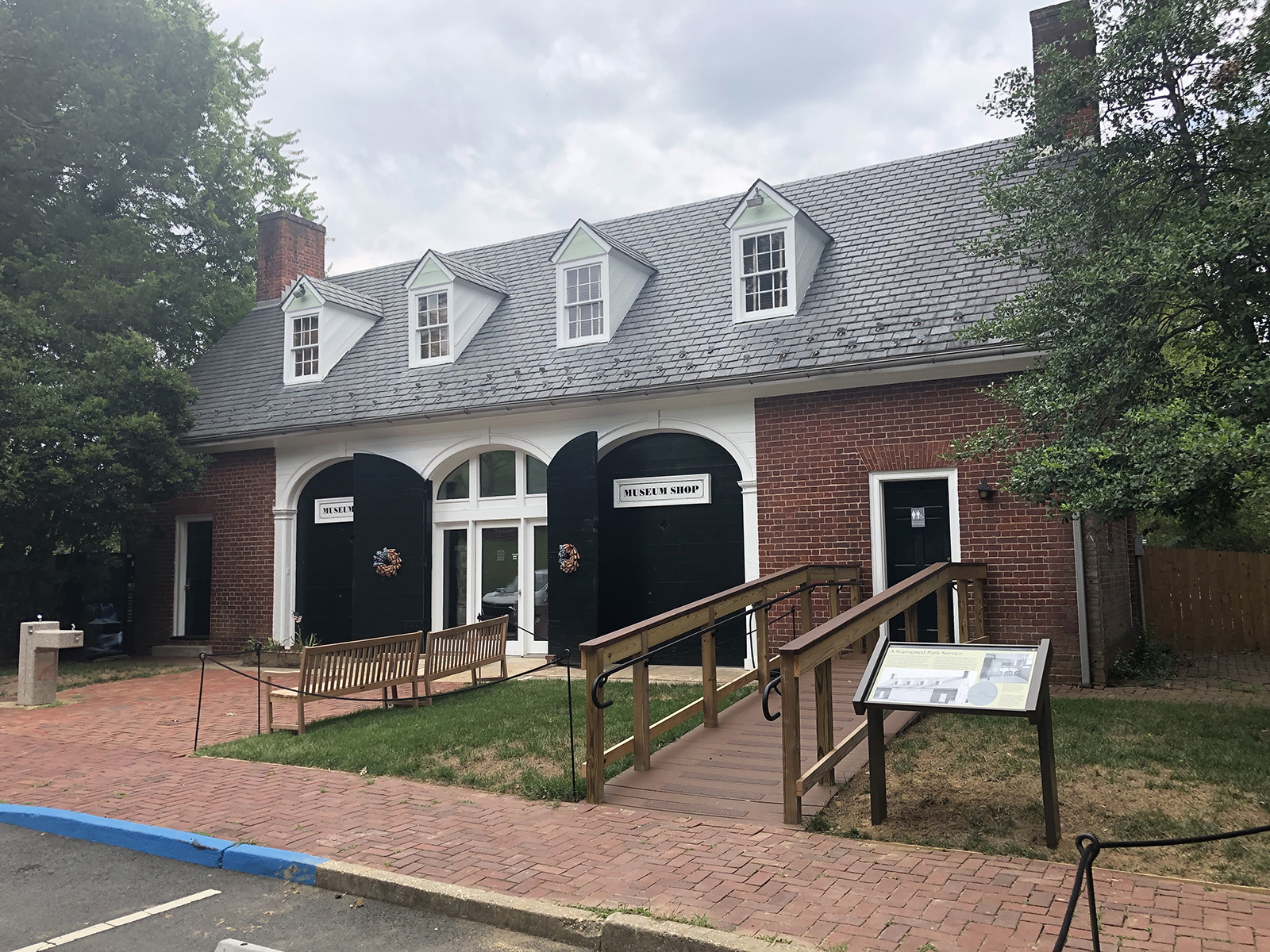 Photo of a building with an interpretive sign outside.