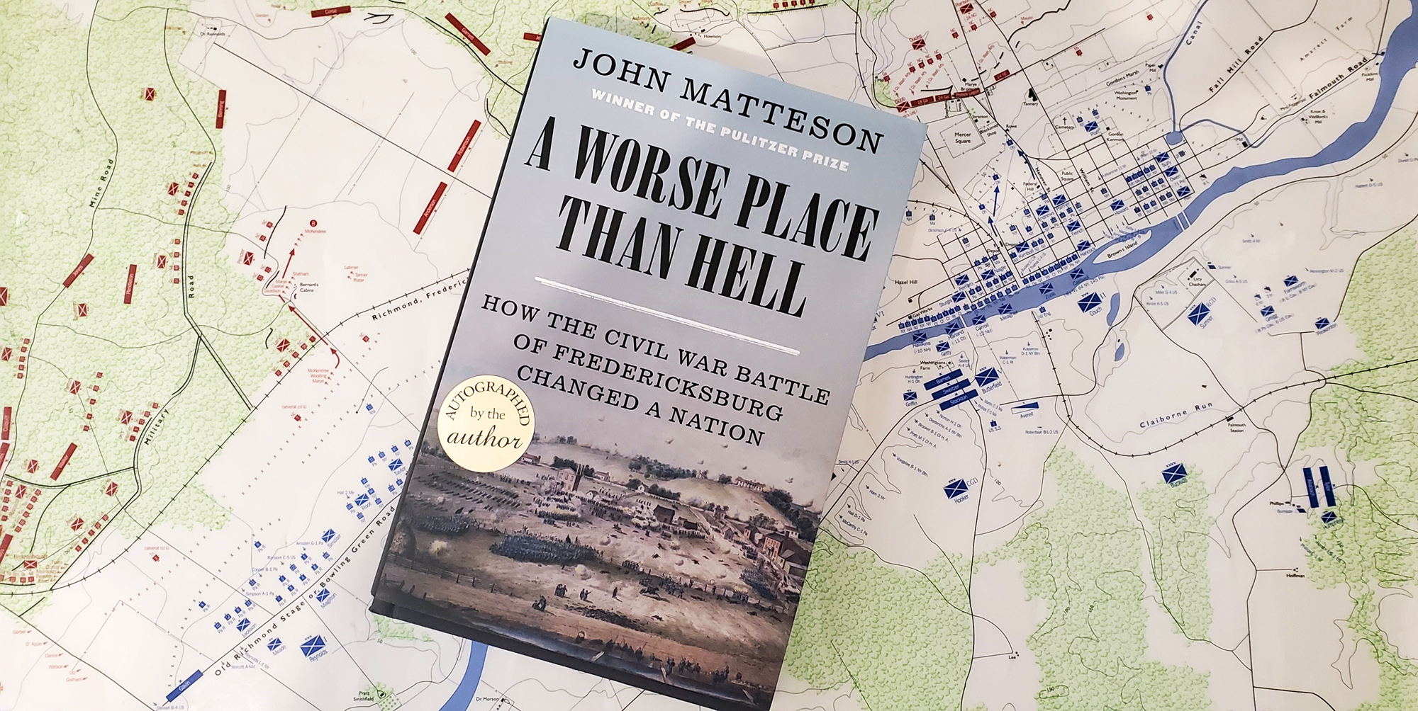 Worse then Hell (cover with background) The book, A Worse Place Than Hell, atop a battle map.
