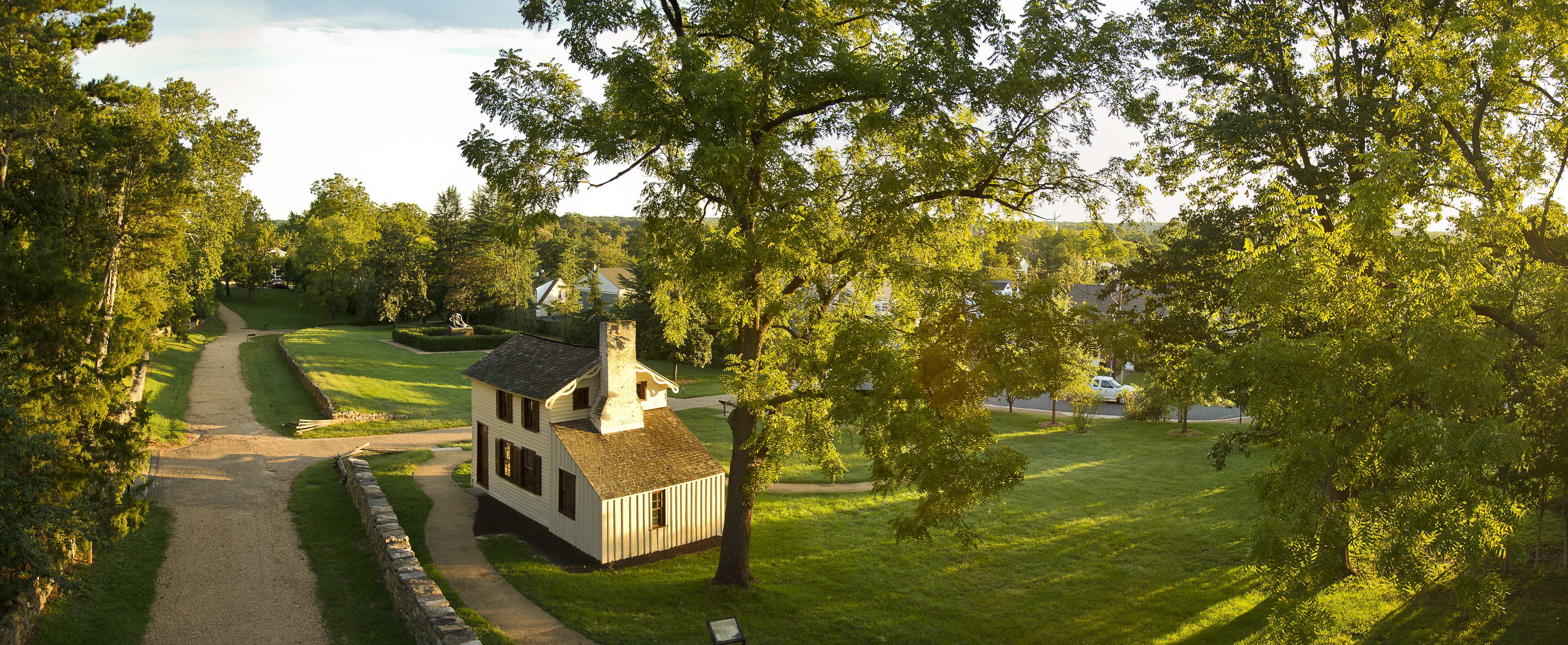 Aerial View of the Sunken Road Aerial view of road with stone wall and small white house