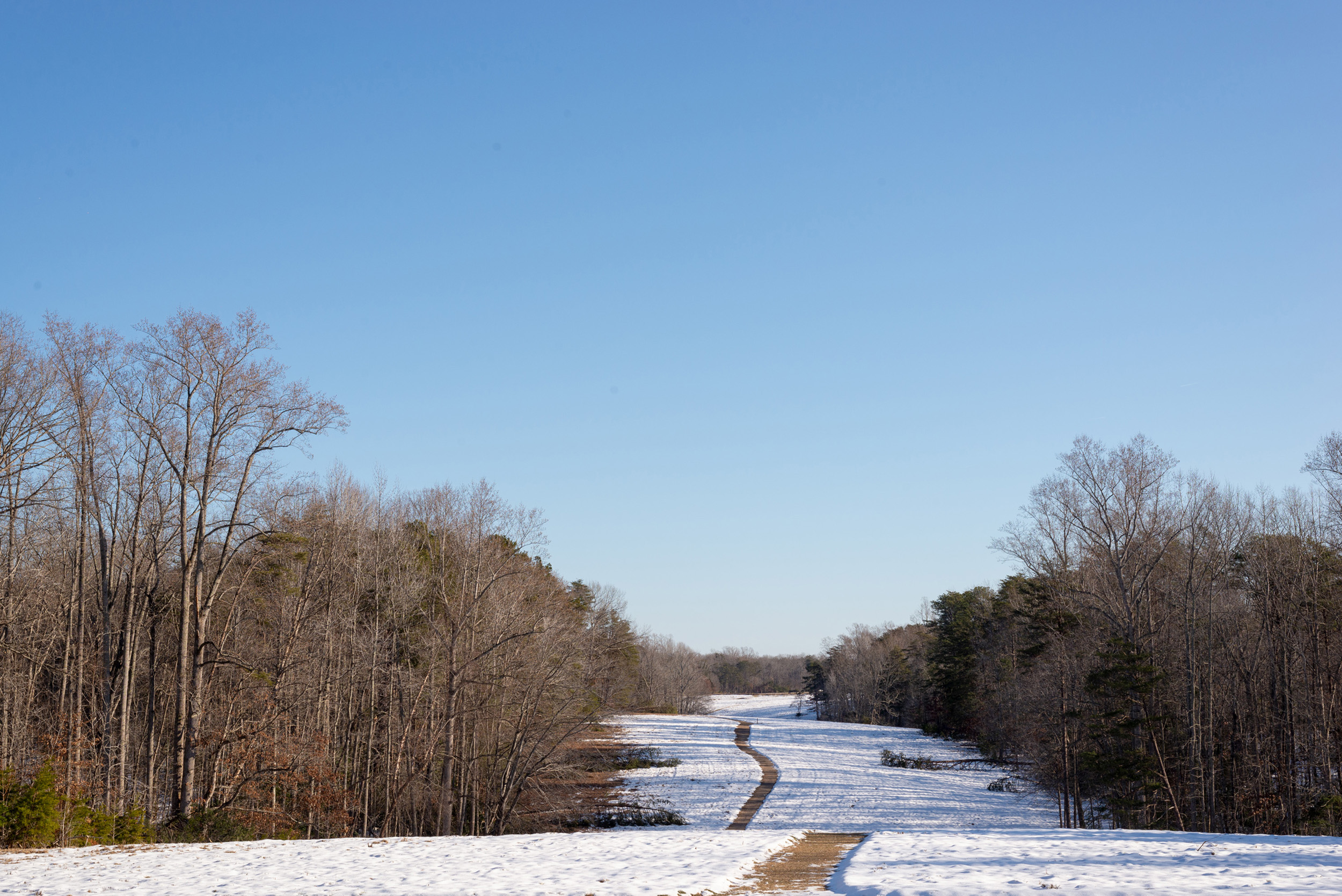 An open field covered in 2 inches of snow.