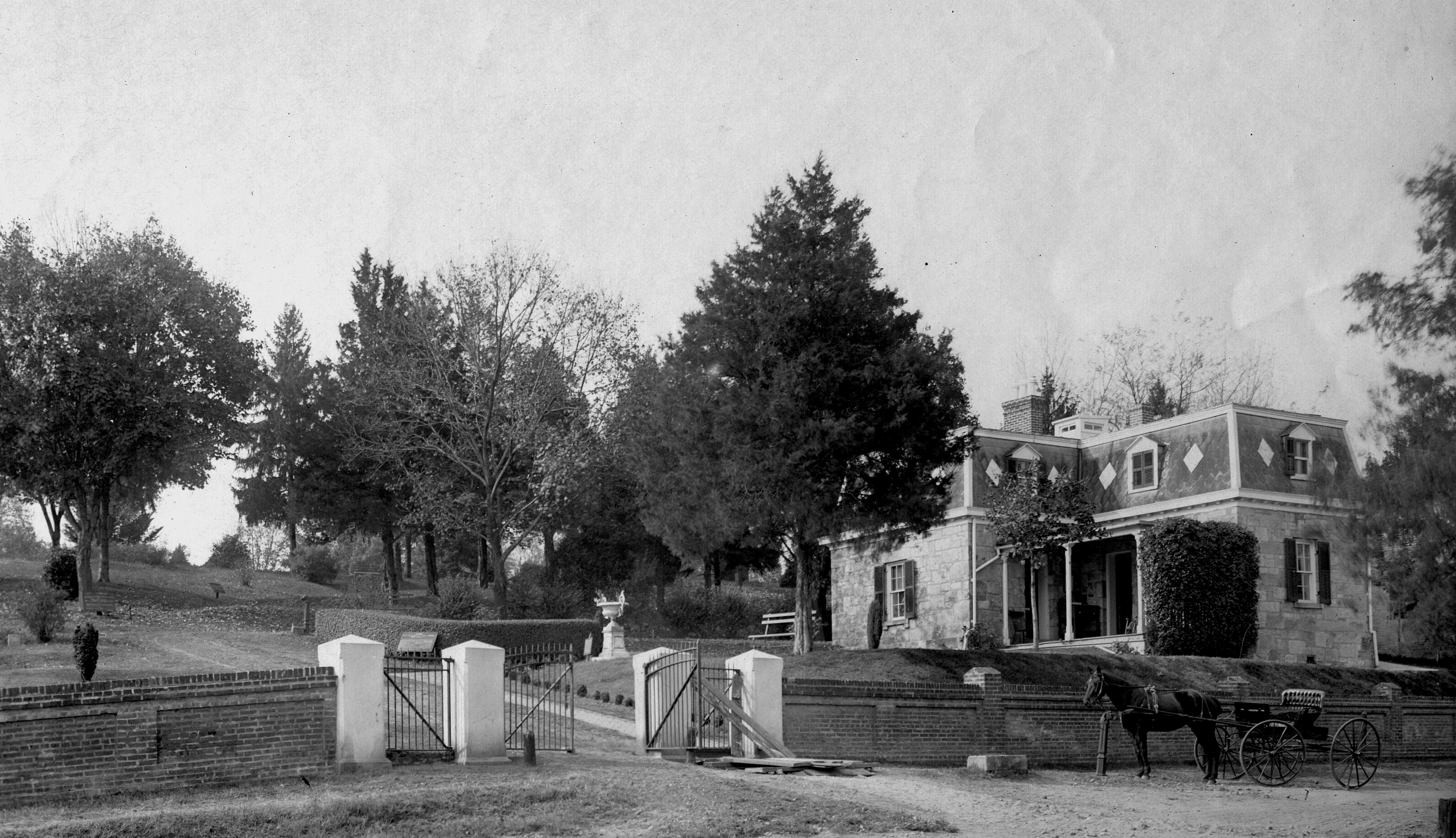 Black and white photo of cemetery lodge building at cemetery entrance.