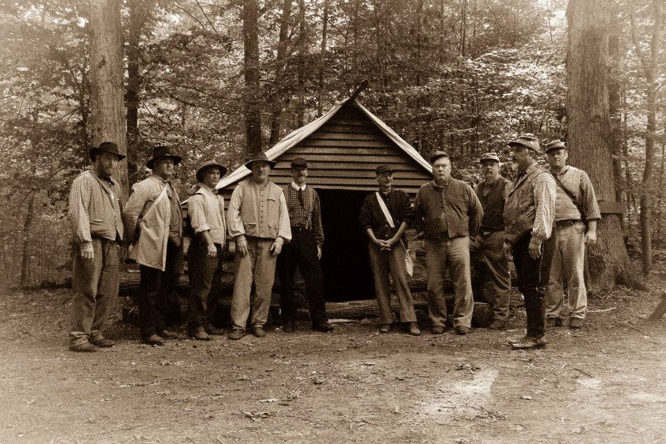 1st South Carolina, Company K Sepia toned photo of reenactors in front of winter hut in woods