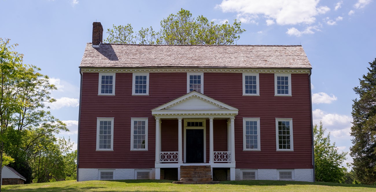 A two story brick buildings on a sunny day.