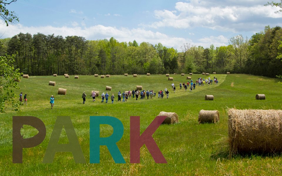 "Park" logo on photo of field with hikers and hay bales "Park" logo on photo of field with hikers and hay bales