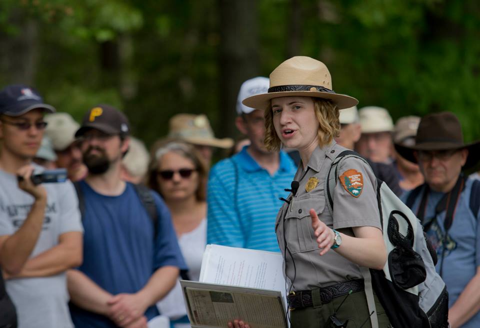 Park historian conducts tour of Spotsylvania Court House battlefield with visitors in background Park historian conducts tour of Spotsylvania Court House battlefield with visitors in background