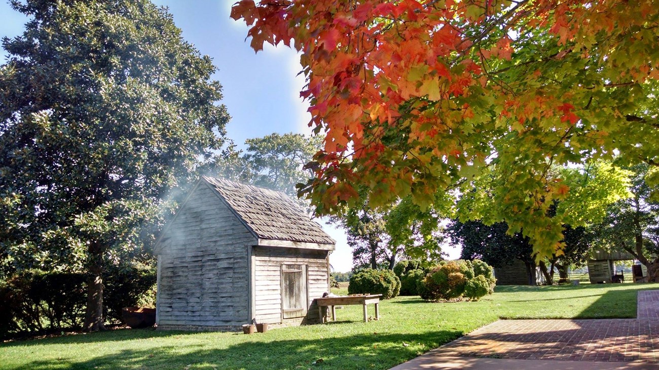 Smoke coming out of the smoke house on a sunny fall day.