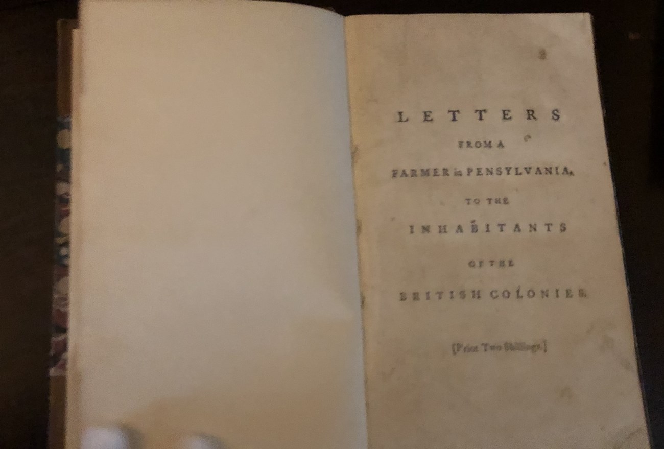 A book with the words "A Letter from a Pennsylvania farmer by John Dickinson"