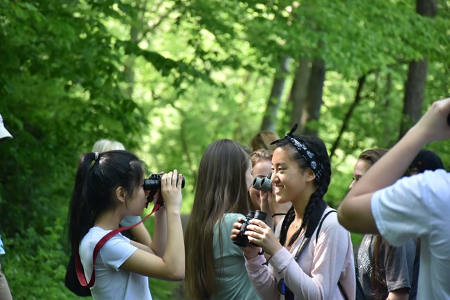 Students practice with their binoculars, and get ready for the bird inventory walk.