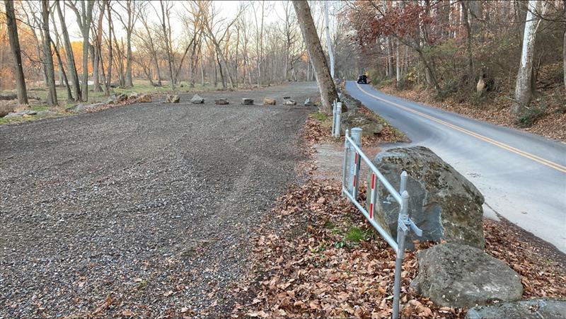 Large boulders block off a section of the parking lot.