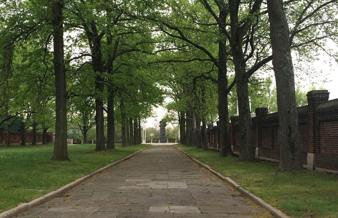 Green leaves cover the stone path leading to the Monument at the end of Fort Christina.