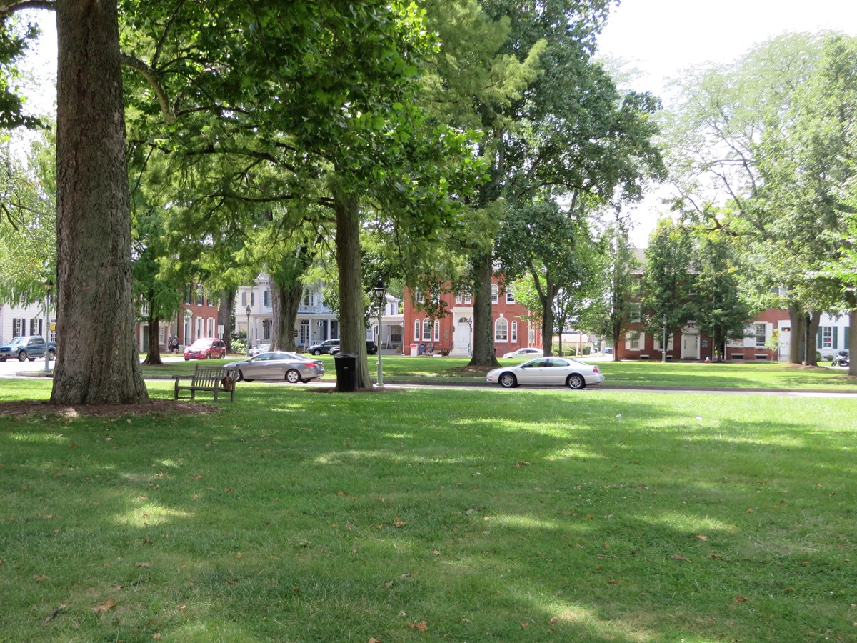 The two green patches of grass that makes up the Historic Green is photographed with State Street in the middle.