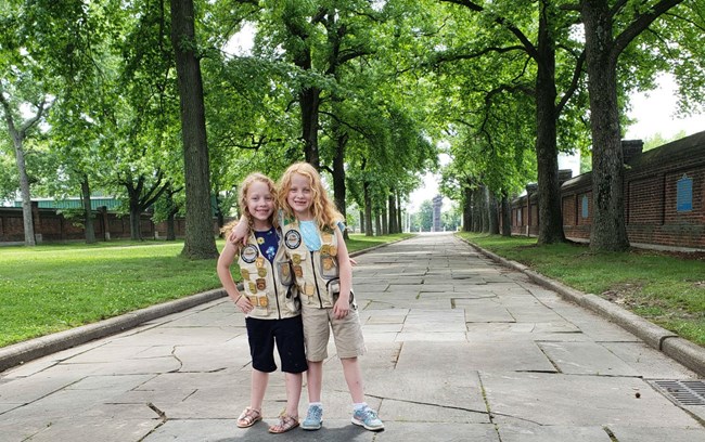 Two Junior Rangers standing in a city park.