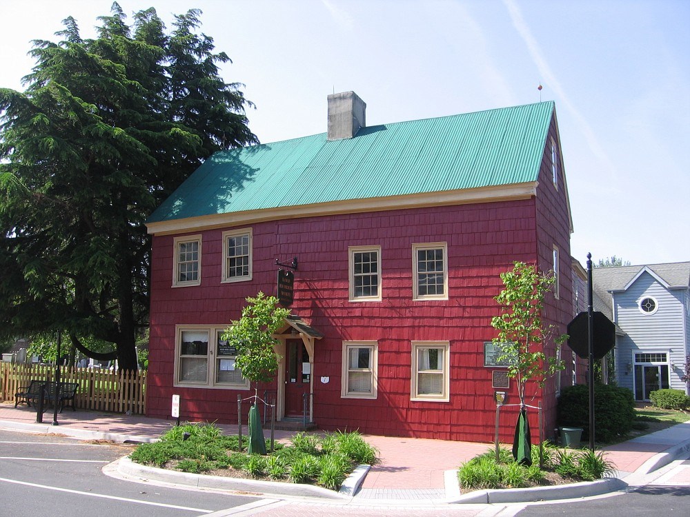 The red Ryves Holt House is photographed on a sunny day.