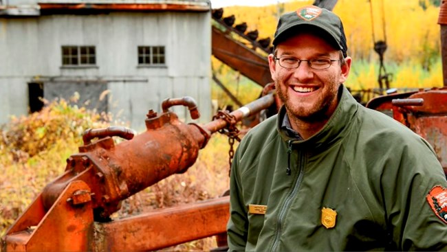 A park ranger in front of the Coal Creek Dredge