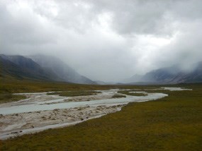 Noatak river winding through a broad valley on a cloudy day. Noatak river winding through a broad valley on a cloudy day.