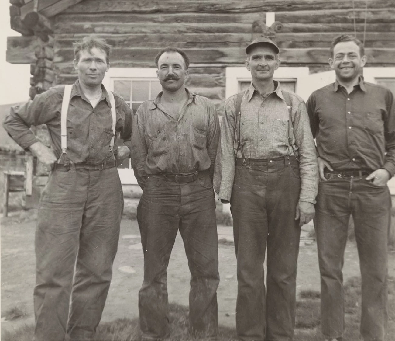 Ernie Johnson, Kenneth Harvey, Jess Allen, Bob Marshall, Wiseman, Alaska, 1938 Four men stand in front of a log cabin