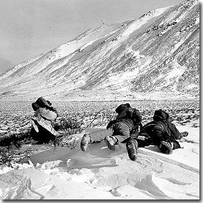 Nunamiut hunters watching caribou in distance (Anchorage Museum of History and Art, Ward W. Wells Collection, WWS-3421-75)