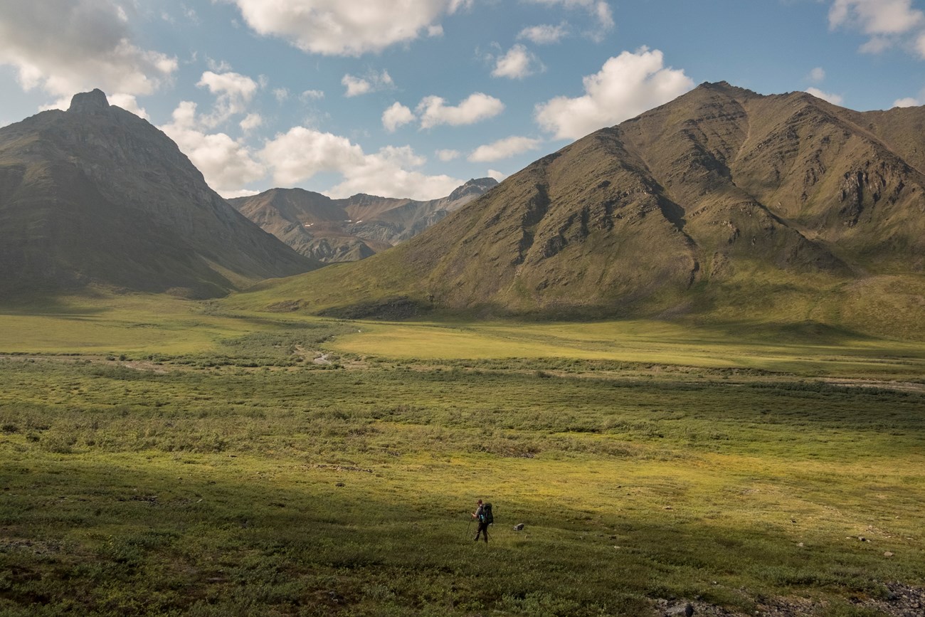 A backpacker in a mountain valley