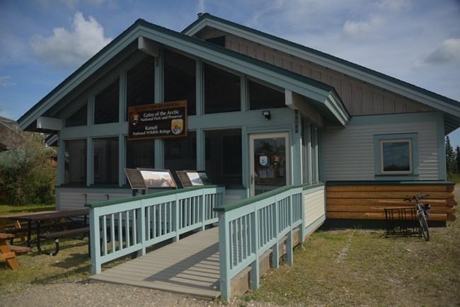 A-frame wooden building with accessible ramp leading to the entrance