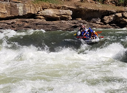 white-water rafters drop into a huge rapid