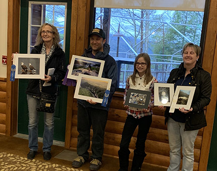 four people holding photographs four people holding photographs