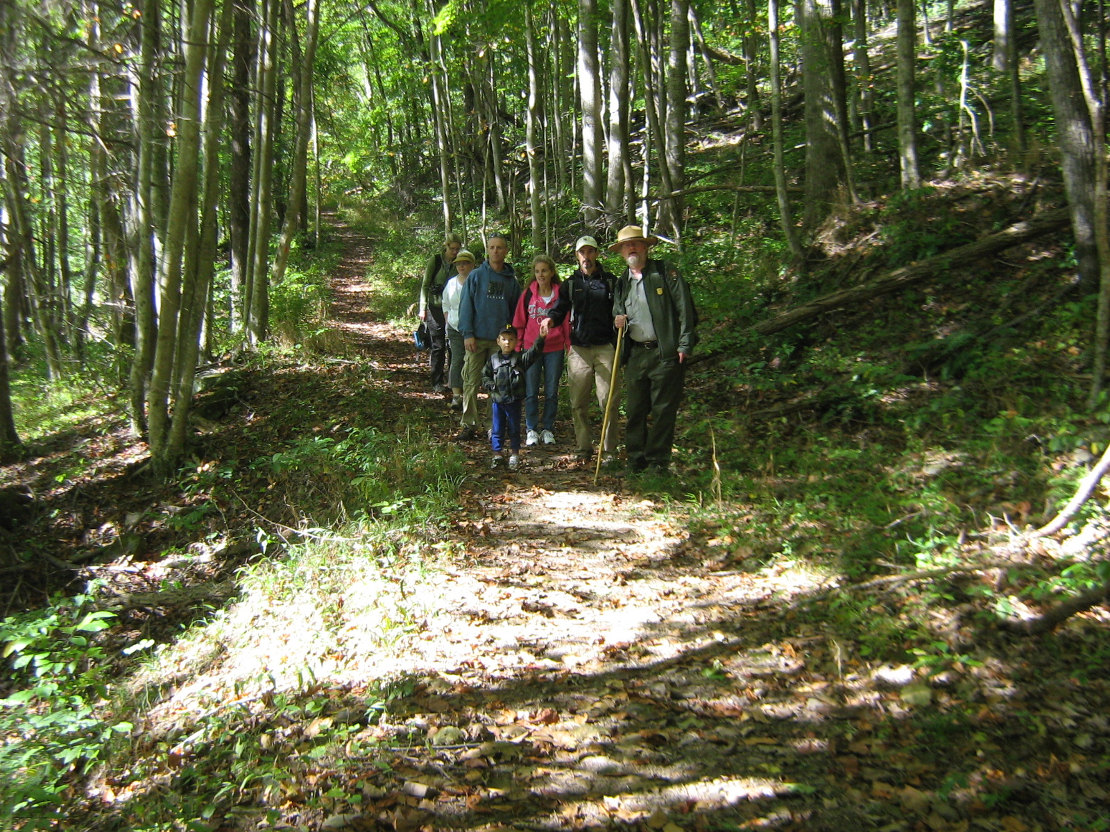 Picture of a National Park Ranger on a guided hike with a group of visitors.