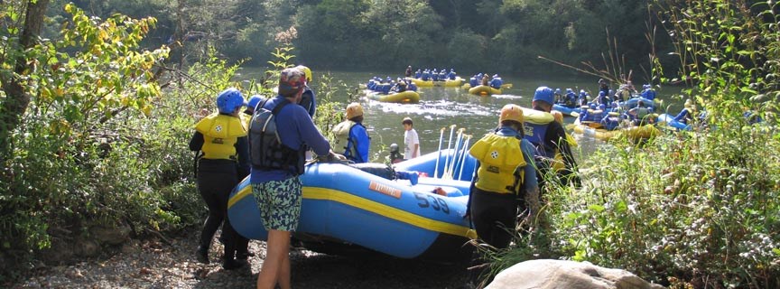 rafters carrying rafts to the river rafters carrying rafts to the river