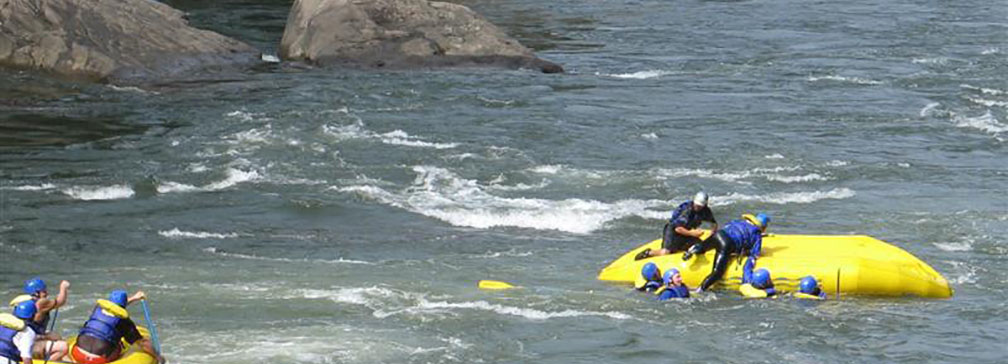 rafters in the river with a capsized raft