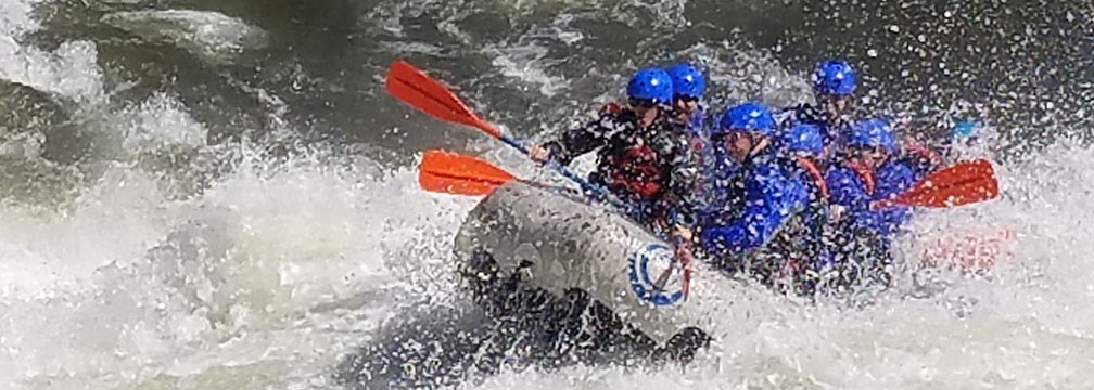 rafters plunging through whitewater