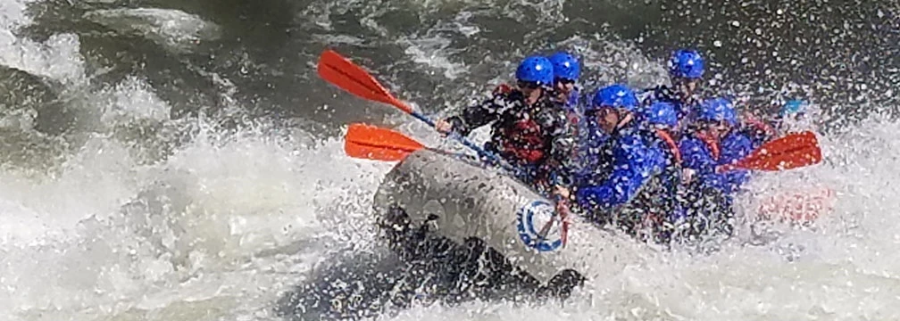 rafters plunging through whitewater rafters plunging through whitewater