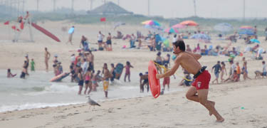 A surf-lifeguard at Sandy Hook Unit responds to a call for help. A surf-lifeguard at Sandy Hook Unit responds to a call for help.