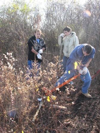 Taylor Ramos with other volunteers removing invasive species
