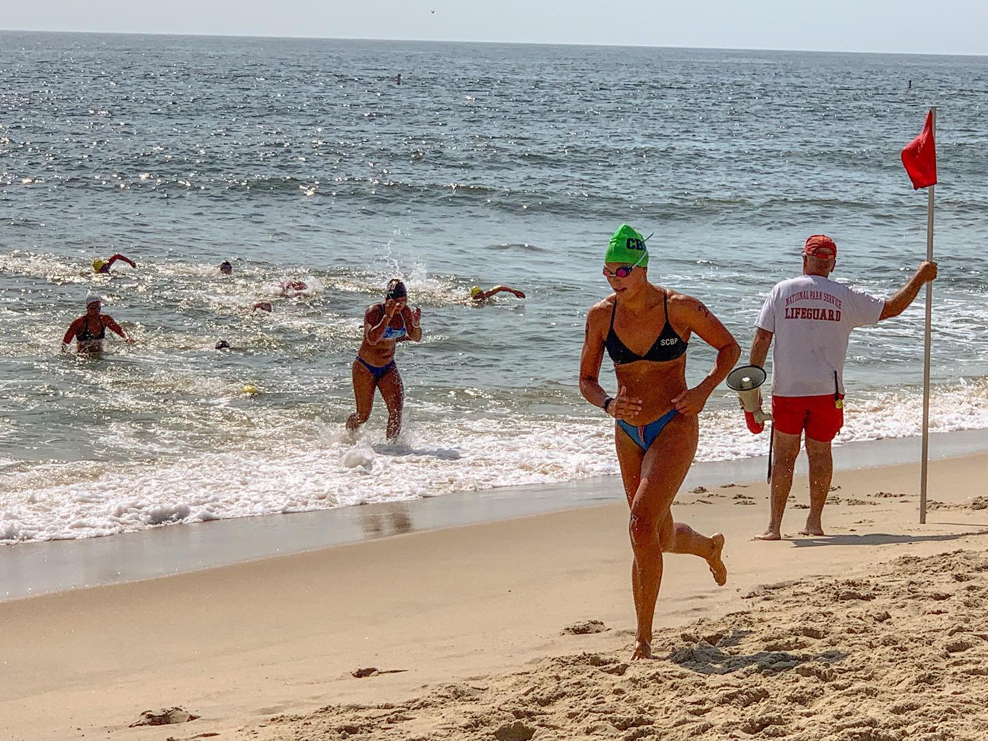 67383450_2195590410549509_1368838074741555200_o Lifeguard running on beach.