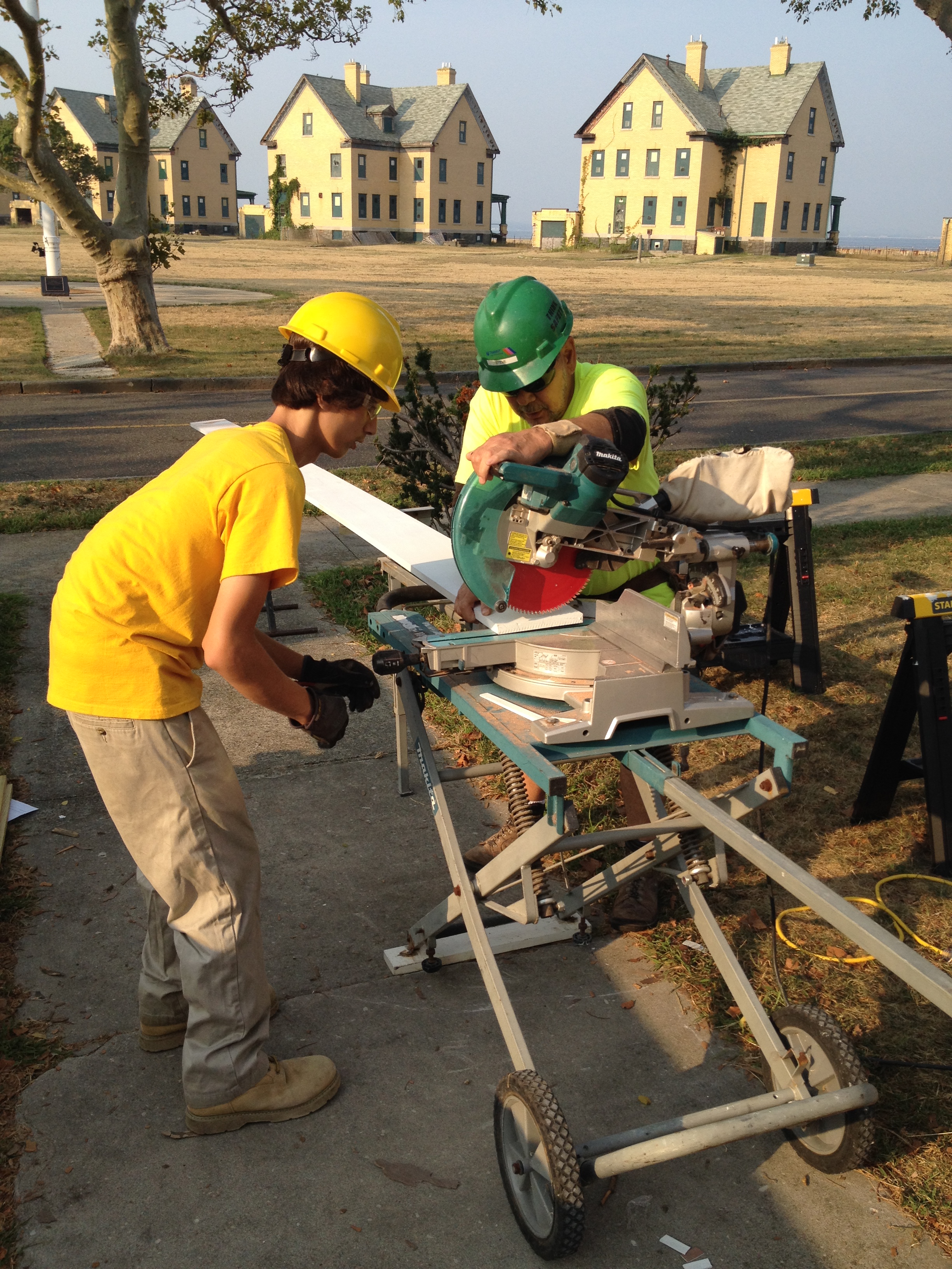 New Jersey Youth Corps Corpsmembers cut wood to rebuild an historic porch at Sandy Hook.