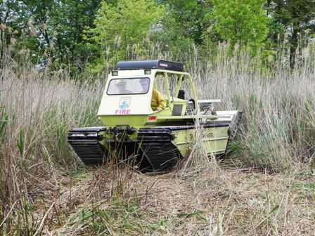 The MarshMaster cuts through phragmites near homes on Grayson Avenue, Staten Island.