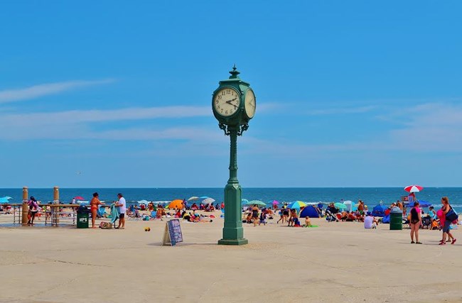 People sunbathing at Riis Park near clock tower. People sunbathing at Riis Park near clock tower.