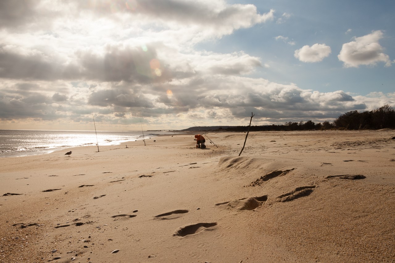 Lone fisherman on the beach