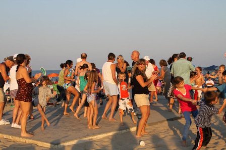 Concert goers having fun and dancing on the beach. Concert goers having fun and dancing on the beach.