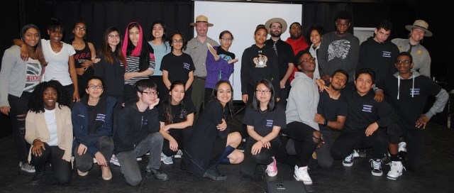 Students of the video festival pose on stage.
