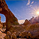 hiking trail passes under a natural arch