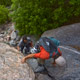 two hikers ascend through a boulder field