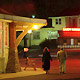 a couple walking in neon-lit area