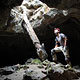 man looks through lava tube